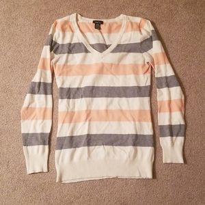 V-neck sweater with gray, peach, and cream stripes